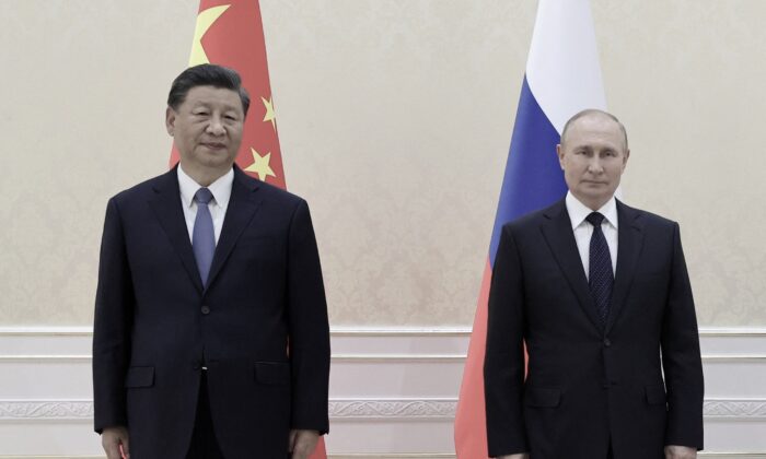 Chinese leader Xi Jinping and Russian President Vladimir Putin pose for photos on the sidelines of the Shanghai Cooperation Organization (SCO) leaders' summit in Samarkand, Uzbekistan, on Sept. 15, 2022. (Alexandr Demyanchuk/Sputnik/AFP via Getty Images)