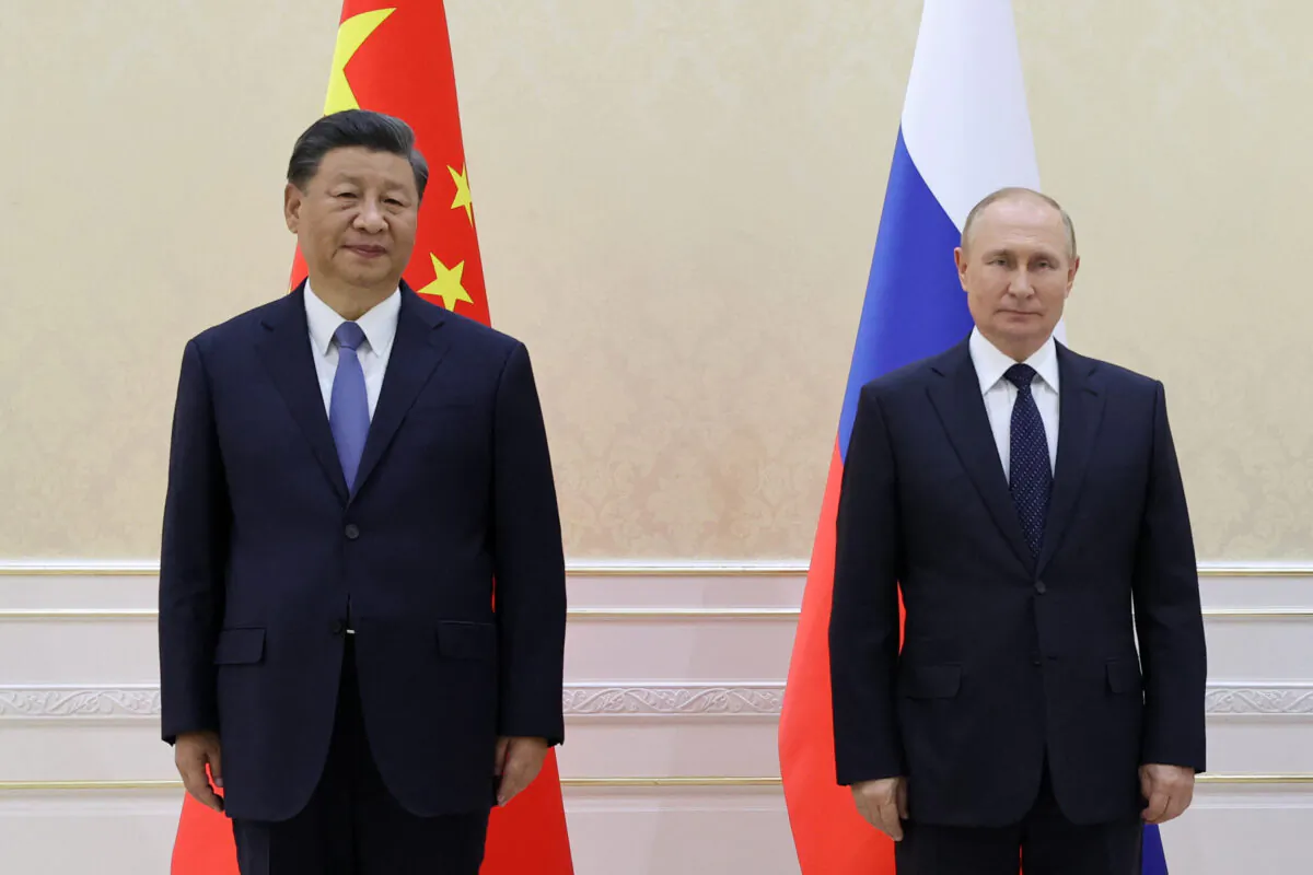 Chinese leader Xi Jinping and Russian President Vladimir Putin pose with Mongolia's President during their trilateral meeting on the sidelines of the Shanghai Cooperation Organisation (SCO) leaders' summit in Samarkand, Uzbekistan, on Sept. 15, 2022. (Alexandr Demyanchuk/SPUTNIK/AFP via Getty Images)