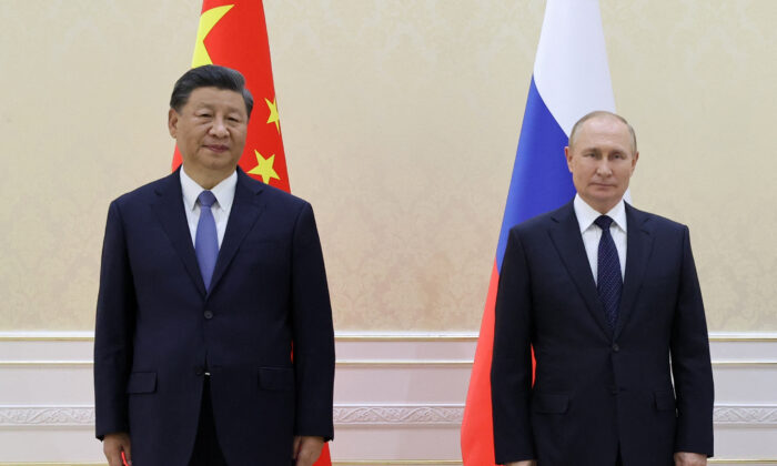 Chinese leader Xi Jinping and Russian President Vladimir Putin pose with Mongolia's President during their trilateral meeting on the sidelines of the Shanghai Cooperation Organisation (SCO) leaders' summit in Samarkand, Uzbekistan, on Sept. 15, 2022. (Alexandr Demyanchuk/SPUTNIK/AFP via Getty Images)
