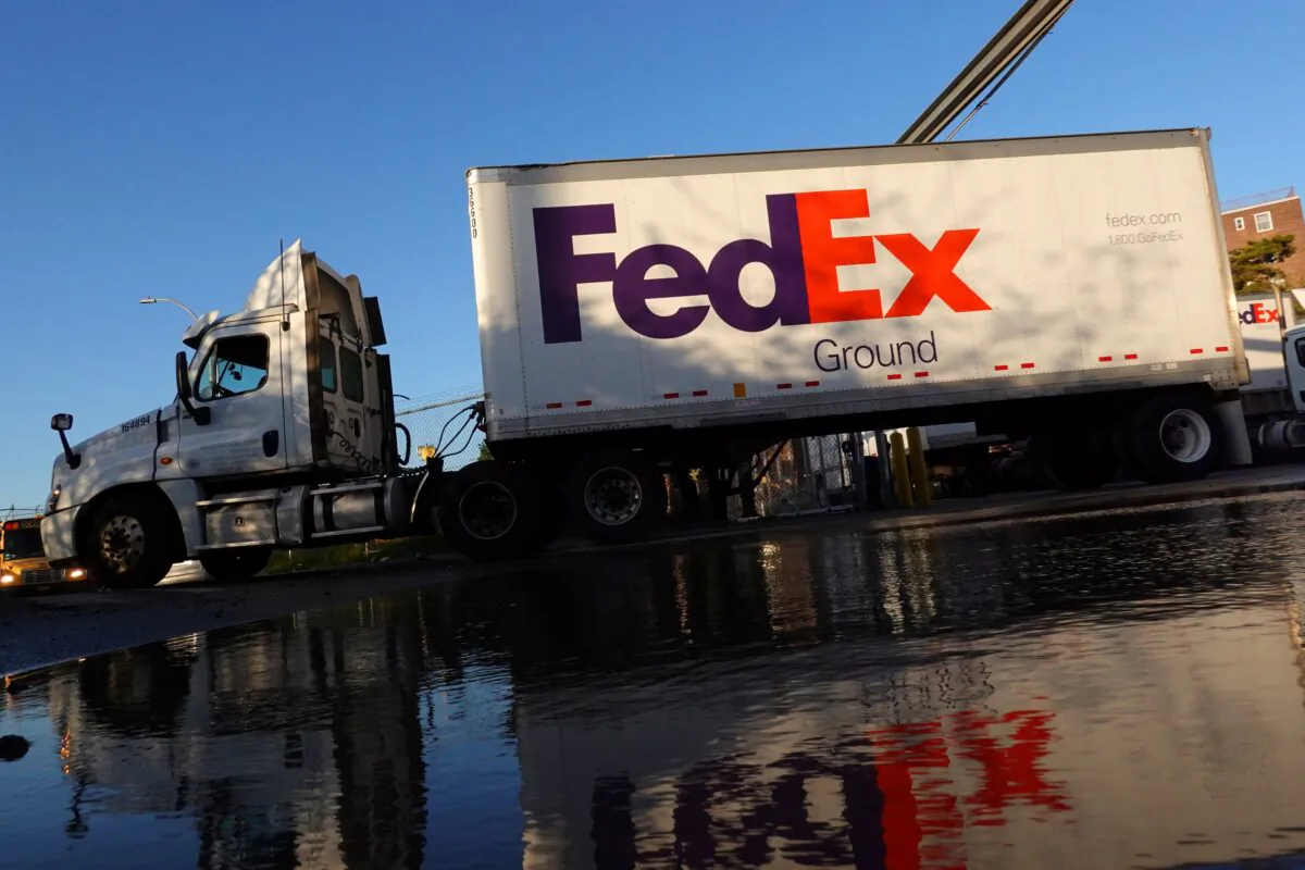 A FedEx delivery truck exits a facility in Brooklyn, New York, on May 9, 2022. (Andrew Kelly/Reuters)