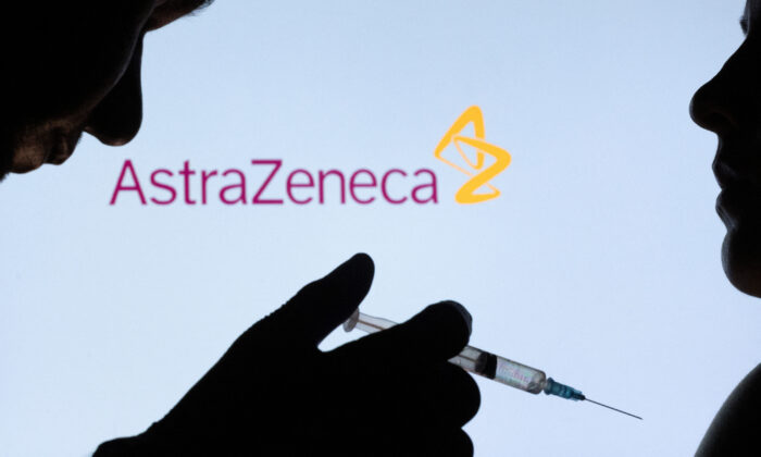 People pose with syringe with needle in front of displayed AstraZeneca logo on Dec. 11, 2021. (Dado Ruvic/Illustration/Reuters)