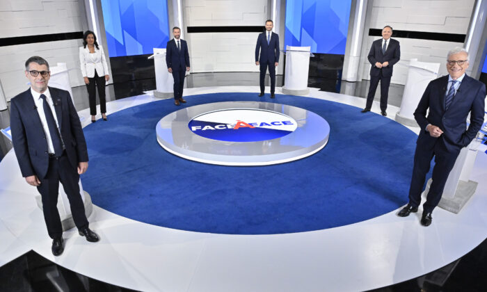 (L-R) Conservative Leader Eric Duhaime, Liberal Leader Dominique Anglade, Quebec Solidaire co-spokesperson Gabriel Nadeau-Dubois, Parti-Quebecois Leader Paul St-Pierre Plamondon, CAQ Leader Francois Legault, and moderator Pierre Brunei stand on the set prior to the leaders debate in Montreal, on Thursday, September 15, 2022. (Martin Chevalier/The Canadian Press)