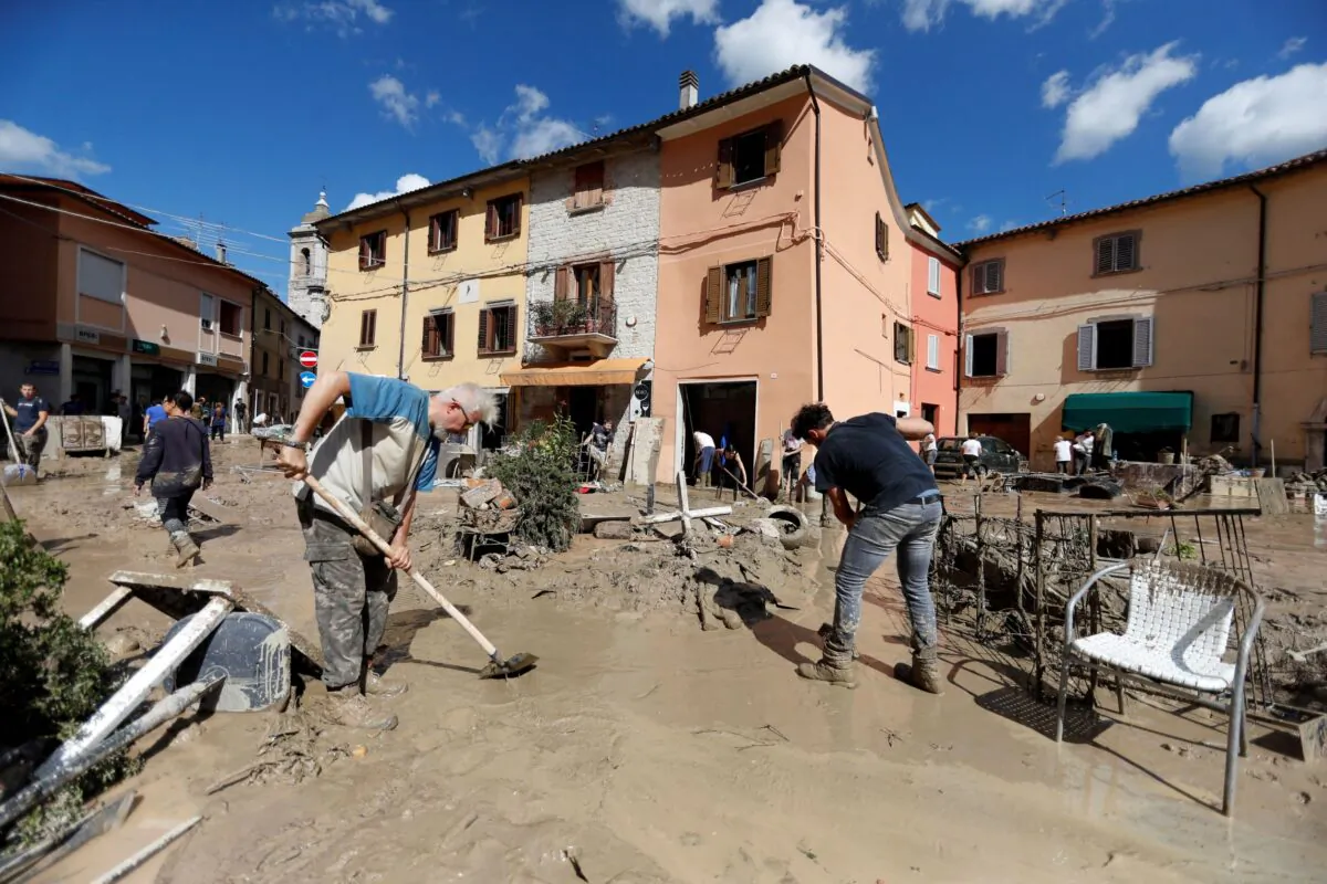 People work to clear way after heavy rain and deadly floods hit the central Italian region of Marche, in Cantiano, Italy, on Sept. 16, 2022. (Yara Nardi/Reuters)