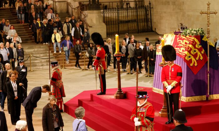 Members of the public file past the coffin of Queen Elizabeth II, draped in the Royal Standard with the Imperial State Crown and the Sovereign's orb and sceptre, in Westminster Hall, London, on Sept. 15, 2022. (Odd Andersen/PA Media)