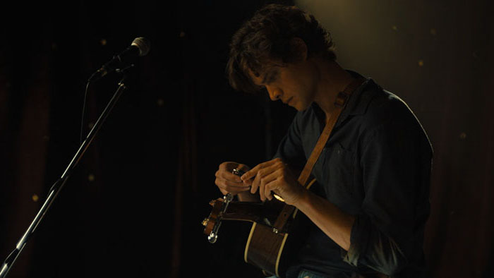 man with guitar in THE SWEARING JAR