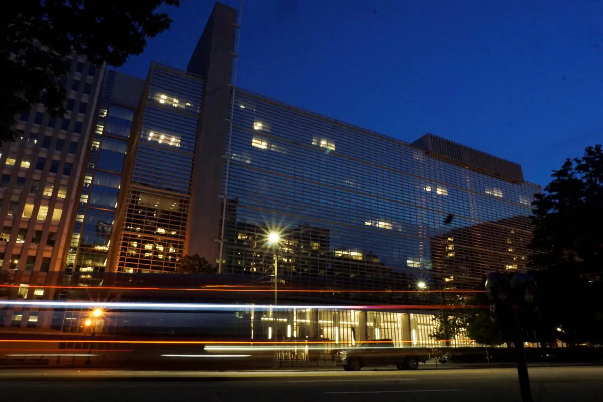 Vehicles pass in front of the World Bank building, which houses the International Centre for Settlement of Investment Disputes, in Washington on May 20, 2022. (Raphael Satter/Reuters)