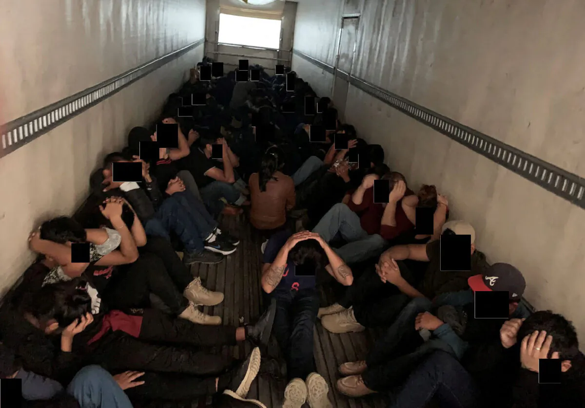 Illegal immigrants who are believed to have crossed the border from Mexico into the United States are seen after the truck they were being transported in was interdicted by law enforcement officers in Laredo, Texas, on Sept. 13, 2022. (Department of Justice/Handout via Reuters)