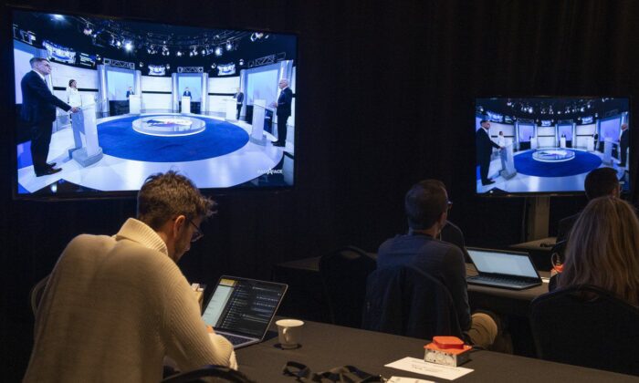 Reporters listen to the Quebec election leaders’ debate in Montreal on Sept. 15, 2022. (The Canadian Press/Paul Chiasson)