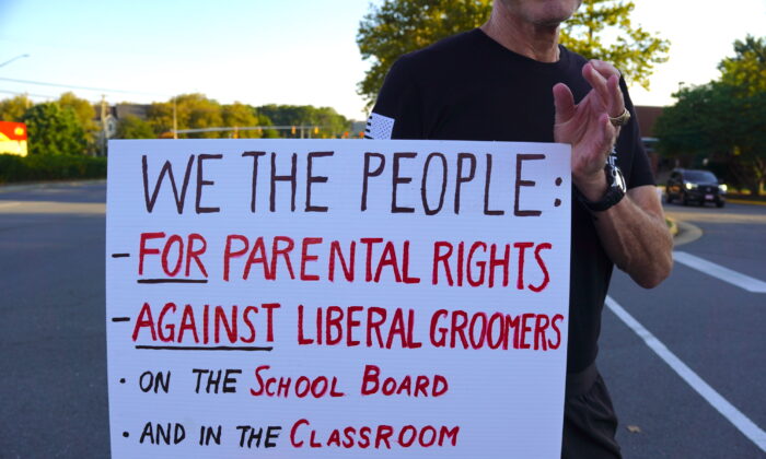 "We the people: for parental rights and against liberal groomers": a local protests outside Luther Jackson Middle School in Falls Church, Va., before a Fairfax County Public Schools board meeting on Sept. 15, 2022. (Terri Wu/The Epoch Times)