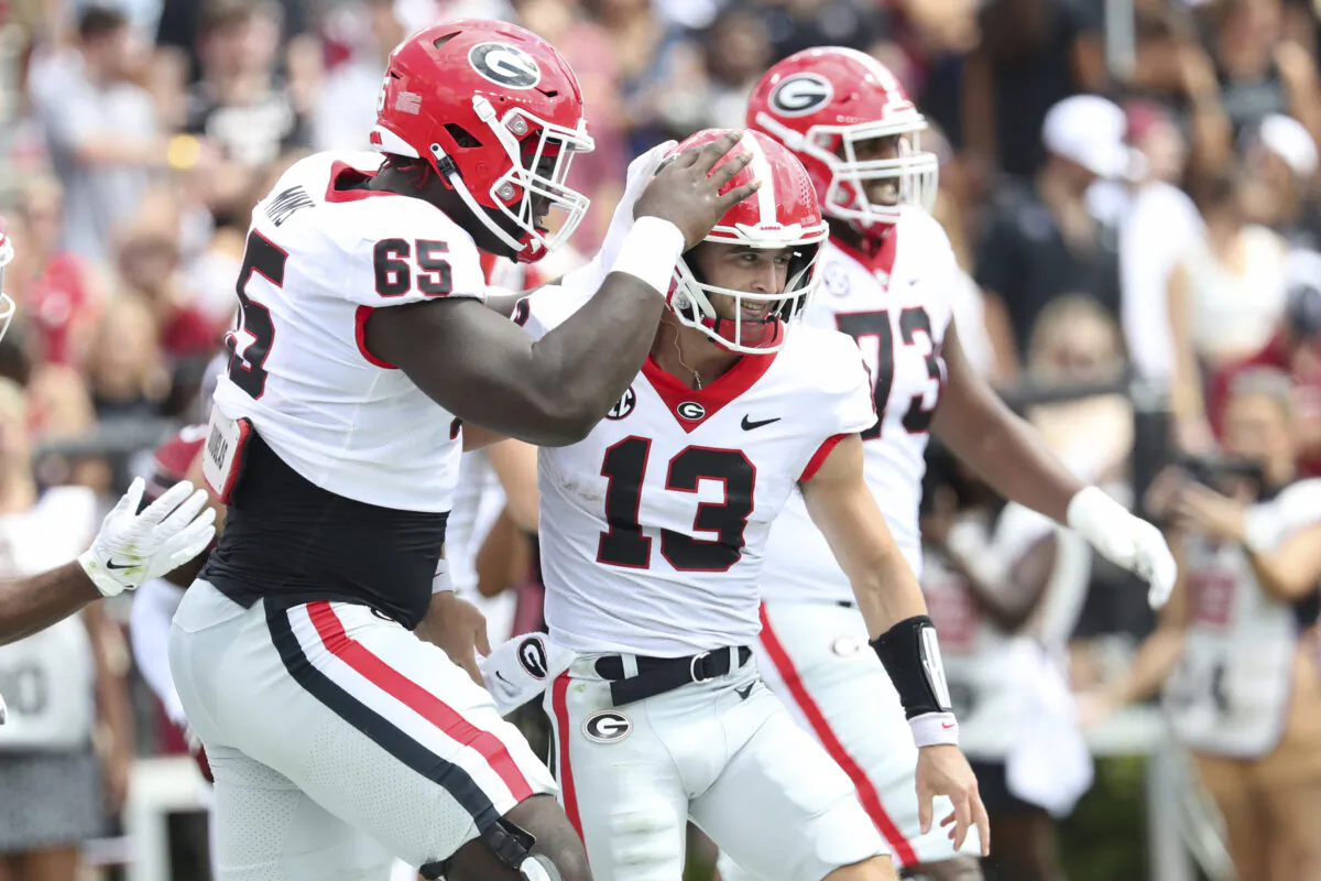 Georgia offensive lineman Amarius Mims (65) congratulates quarterback Stetson Bennett (13) during the first half of an NCAA college football game against South Carolina in Columbia, S.C., on Sept. 17, 2022. (Artie Walker Jr./Ap Photo)
