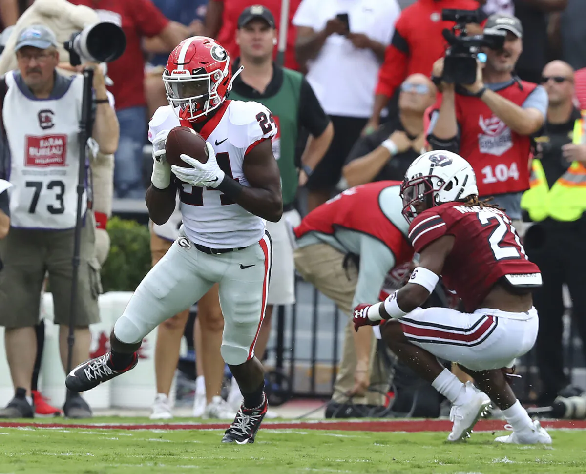 Georgia defensive back Malaki Starks intercepts a pass intended for South Carolina running back Juju McDowell during the first half of an NCAA college football game in Columbia, S.C., on Sept. 17, 2022. (Curtis Compton/Atlanta Journal—Constitution via AP Photo)