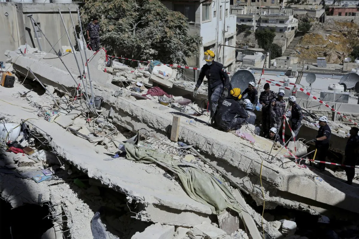 Rescue teams from the Jordanian Civil Defense carry out a search operation for residents of a four-storey apartment building that collapsed on Sept. 13, 2022, in the Jordanian capital, Amman, on Sept. 15, 2022. (Raad Al-Adayleh/AP Photo)