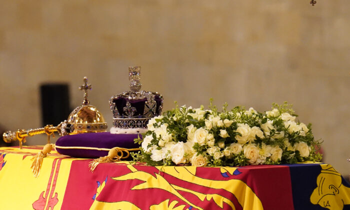 The coffin of Queen Elizabeth II, draped in the Royal Standard with the Imperial State Crown and the Sovereign's orb and sceptre, lying in state on the catafalque in Westminster Hall, at the Palace of Westminster, London, on Sept. 17, 2022. (James Manning/PA Media)