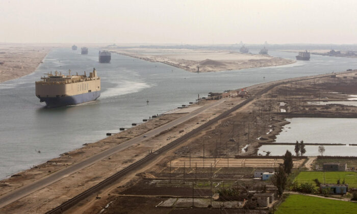 Cargo ships navigate in the Suez Canal between Port Said and Ismailia, about 100 kilometers northeast of Cairo, on Nov. 24, 2008. (Cris Bouroncle/AFP via Getty Images)