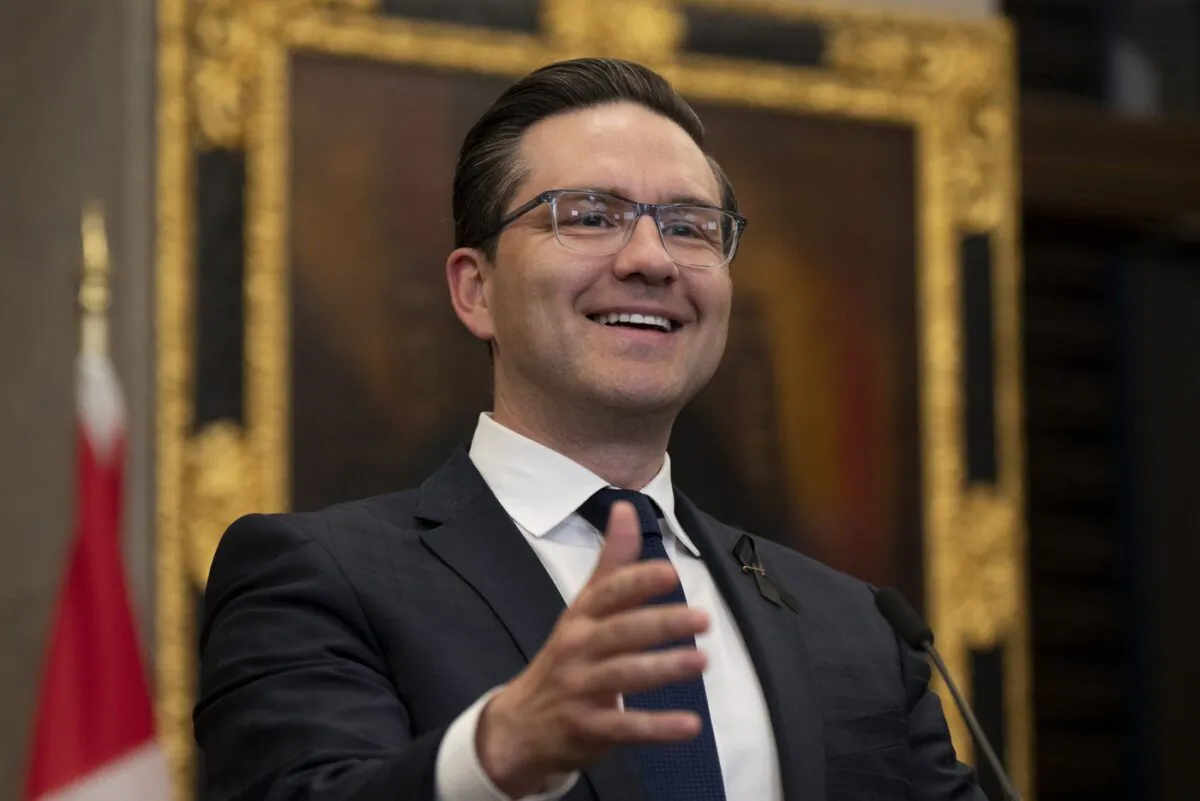 Conservative Leader Pierre Poilievre smiles as a reporter asks him questions during his opening remarks in the Foyer of the House of Commons in Ottawa Sept. 13, 2022. (The Canadian Press/Adrian Wyld)