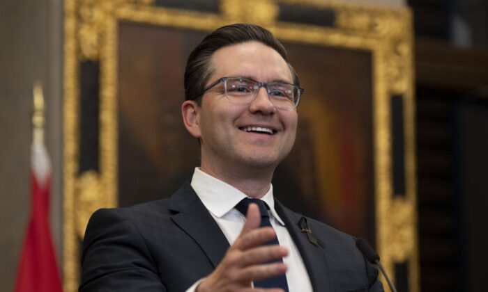 Conservative Leader Pierre Poilievre smiles as a reporter asks him questions during his opening remarks in the Foyer of the House of Commons in Ottawa Sept. 13, 2022. (The Canadian Press/Adrian Wyld)