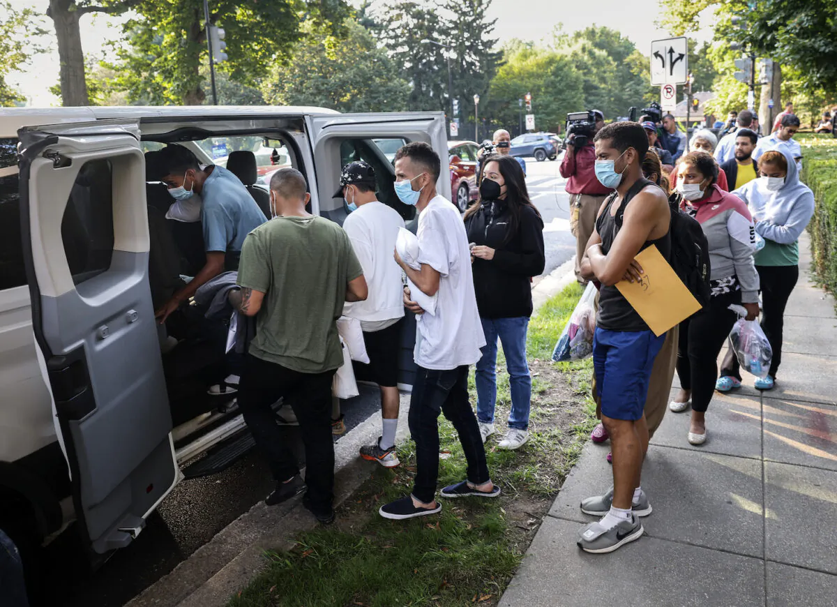 Illegal immigrants from Central and South America load into vans near the residence of Vice President Kamala Harris after being dropped off in Washington, on Sept. 15, 2022. (Kevin Dietsch/Getty Images)
