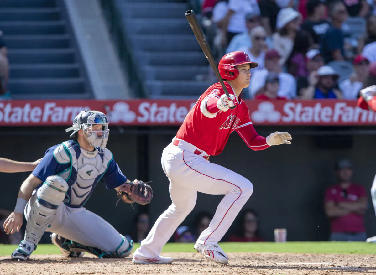 Los Angeles Angels designated hitter Shohei Ohtani, front right, grounds out as Seattle Mariners catcher Cal Raleigh, left, looks on during the seventh inning of a baseball game in Anaheim, Calif., on Sept. 18, 2022. (Alex Gallardo/AP Photo)