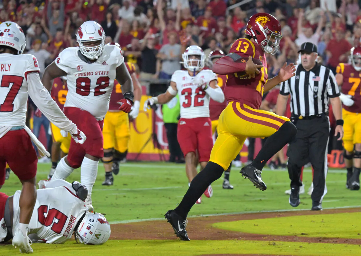 Quarterback Caleb Williams (13) of the USC Trojans breaks away from defensive end Da'Marcus Johnson (52) of the Fresno State Bulldogs and runs into the end zone for a touchdown in the first half at United Airlines Field at the Los Angeles Memorial Coliseum in Los Angeles, on September 17, 2022. (Jayne Kamin-Oncea/Getty Images)