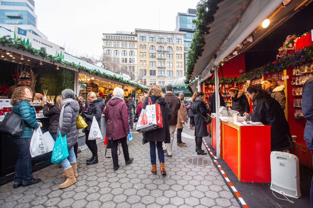Christmas shoppers walk through the Union Square Greenmarket and Holiday Market boutiques in Manhattan in December 2018. (Dreamstime/TNS)