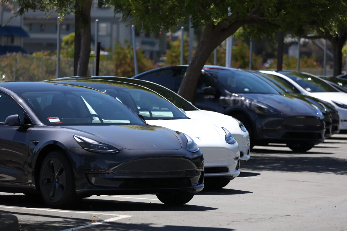 Brand-new Tesla cars sit in a parking lot at a Tesla showroom location in Corte Madera, Calif., on June 27, 2022. (Justin Sullivan/Getty Images)