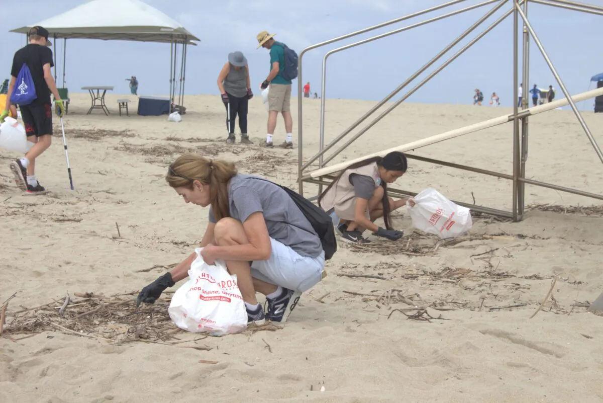 Volunteers picking up trash on a cleanup event coordinated by Orange County Coastkeeper as part of California Coastal Cleanup Day in Huntington Beach, Calif., on Sept. 17, 2022. (Courtesy of Orange County Coastkeeper)