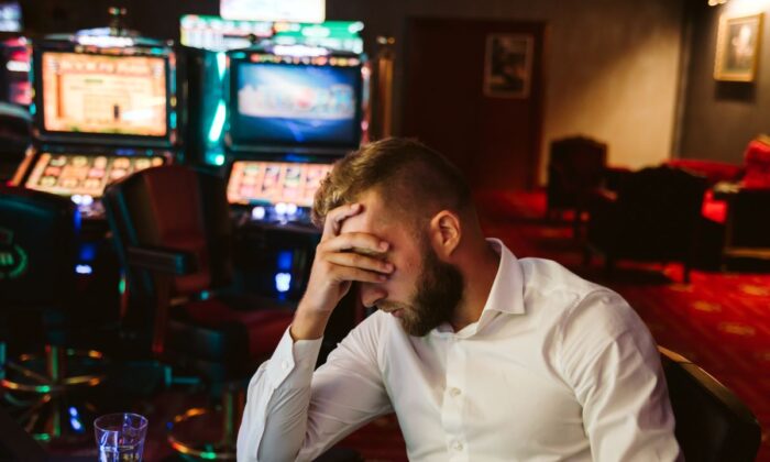 The Tasmanian government is introducing a pre-commitment  card-based system to to protect people from spending more than they can afford on poker machines.(Zoran/Adobe Stock)