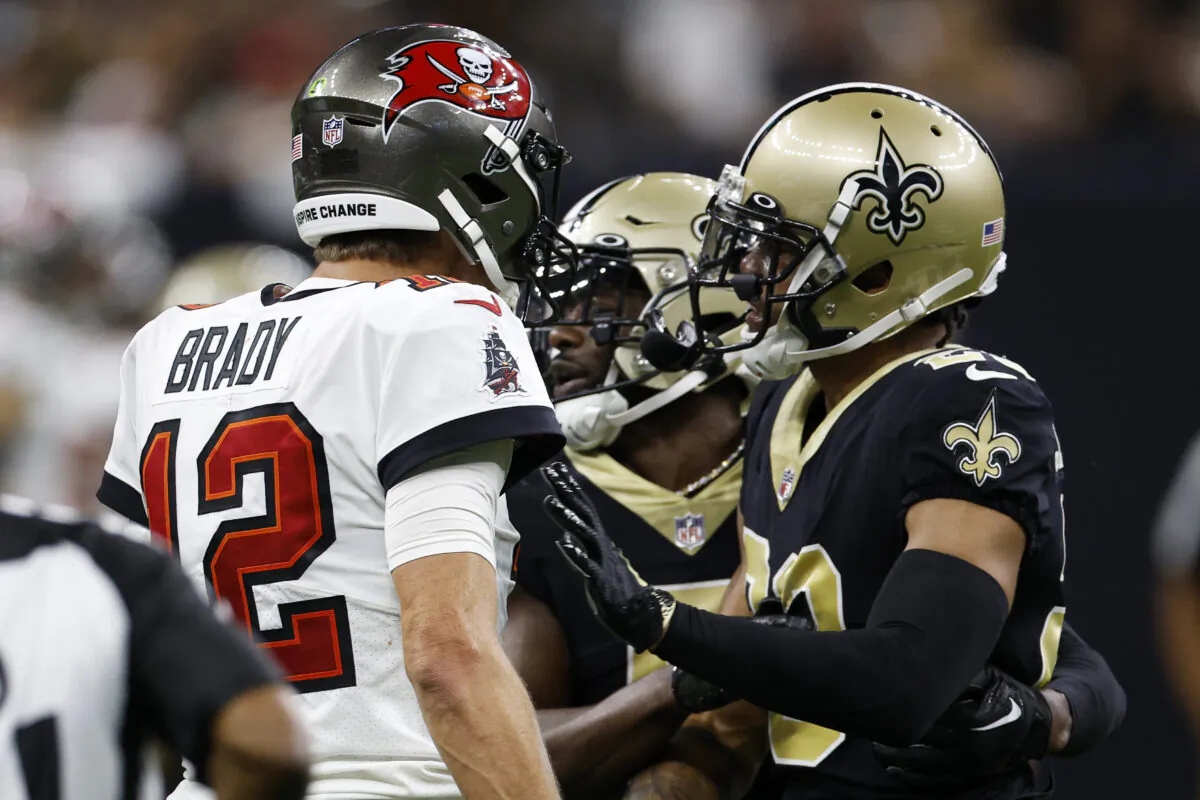Tom Brady (12) of the Tampa Bay Buccaneers and Marshon Lattimore (23) of the New Orleans Saints argue during the fourth quarter of the game at Caesars Superdome in New Orleans, on Sept. 18, 2022. (Chris Graythen/Getty Images)