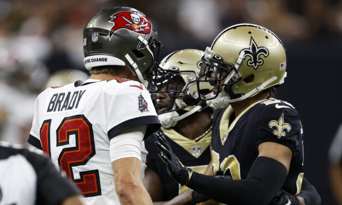 Tom Brady (12) of the Tampa Bay Buccaneers and Marshon Lattimore (23) of the New Orleans Saints argue during the fourth quarter of the game at Caesars Superdome in New Orleans, on Sept. 18, 2022. (Chris Graythen/Getty Images)
