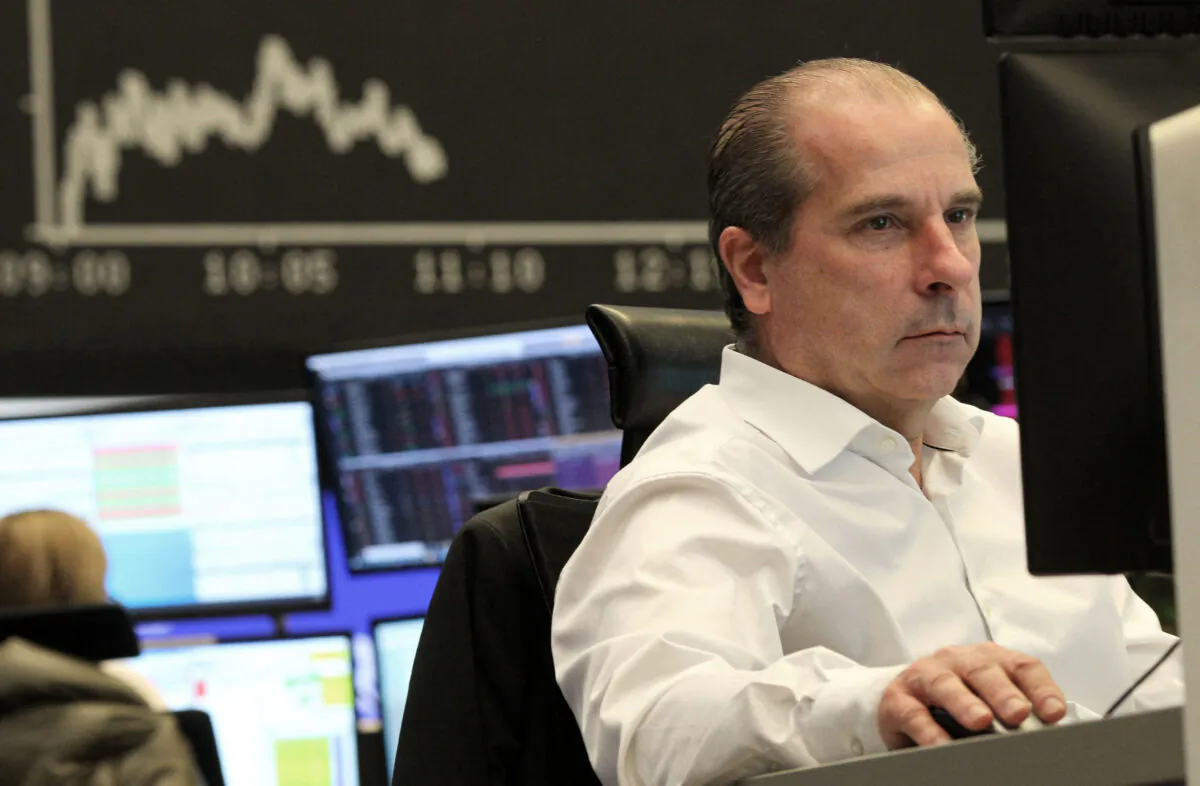 A trader works in front of a board displaying Germany's share index DAX at the stock exchange in Frankfurt am Main, western Germany, on Feb. 24, 2022. (Daniel Roland/AFP via Getty Images)