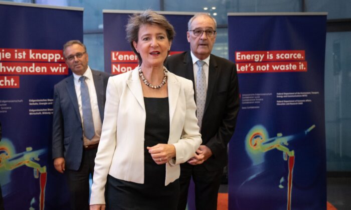 (L-R) President of the Swiss conference of cantonal energy directors Roberto Schmidt, Switzerland's Minister of Infrastructure, Transport, Environment, and Energy Simonetta Sommaruga, and Economy Minister Guy Parmelin arrive to give a press conference to announce measures of possible energy shortages this winter, in Bern on Aug. 31, 2022. (Fabrice Coffrini/AFP via Getty Images)