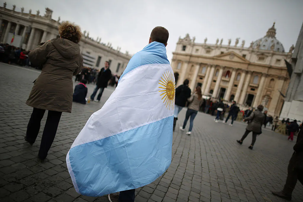 A boy walks in St. Peter's Square wrapped in the flag of Argentina before Pope Francis gave his first Angelus blessing in Vatican City, Vatican, on March 17, 2013. (Peter Macdiarmid/Getty Images)