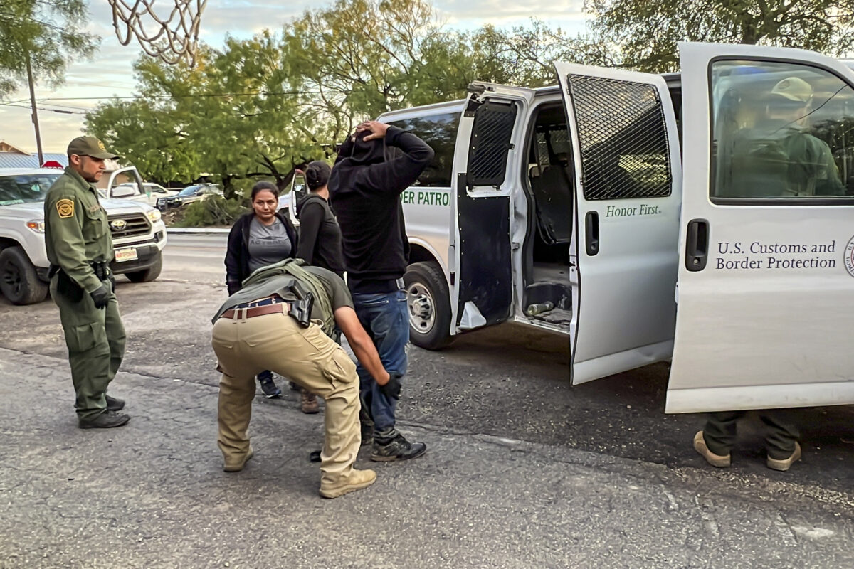 Border Patrol agents take into custody several illegal immigrants who were being smuggled from the U.S.–Mexico border to San Antonio, in Brackettville, Texas, on Aug. 26, 2022. (Charlotte Cuthbertson/The Epoch Times)