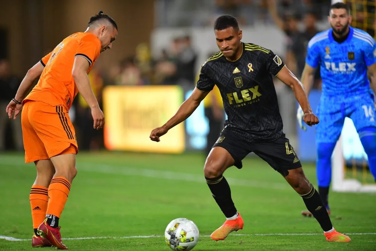 Los Angeles FC defender Eddie Segura (4) moves the ball against Houston Dynamo forward Sebastian Ferreira (9) with LAFC goalkeeper Maxime Crepeau at goal during the first half at Banc of California Stadium in Los Angeles on Sept. 18, 2022. (Gary A. Vasquez-USA TODAY Sports via Field Level Media)