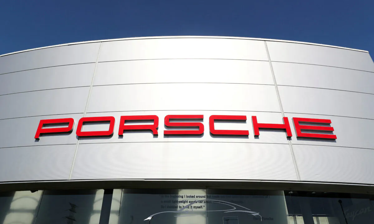A logo of Porsche outside a Porsche car dealer in Brussels on May 28, 2020. (Yves Herman/Reuters)