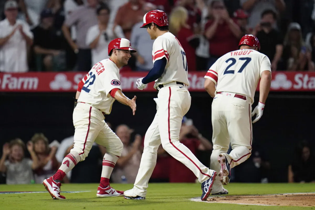 Los Angeles Angels designated hitter Shohei Ohtani (17) celebrates with David Fletcher (22) and Mike Trout (27) after hitting a home run during the sixth inning of a baseball game against the New York Yankees in Anaheim, Aug. 31, 2022. (Ashley Landis/ AP Photo)