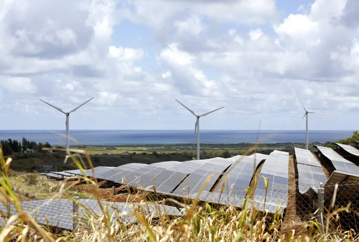 Windmills and solar panels are shown in Kahuku, Hawaii, on Aug. 22, 2022. (AP Photo/Caleb Jones)