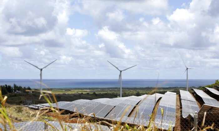 Windmills and solar panels are shown in Kahuku, Hawaii, on Aug. 22, 2022. (AP Photo/Caleb Jones)