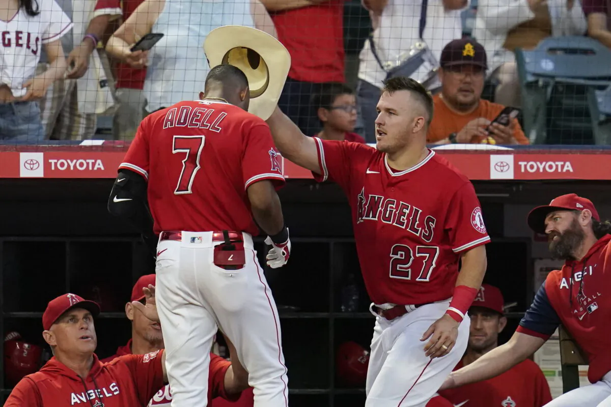 Los Angeles Angels' Mike Trout (27) places a cowboy hat on the head of Jo Adell (7) after Adell hit a home run during the second inning of a baseball game against the Detroit Tigers in Anaheim, Calif., on Sept. 6, 2022. (Ashley Landis/AP Photo)