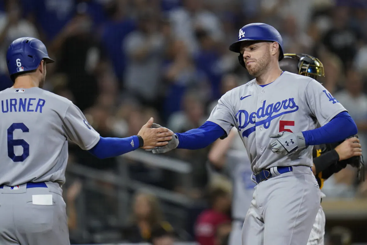 Los Angeles Dodgers' Freddie Freeman, right, is greeted by teammate Trea Turner after hitting a two-run home run during the seventh inning of a baseball game against the San Diego Padres, in San Diego, Sept. 10, 2022. (Gregory Bull/AP Photo)