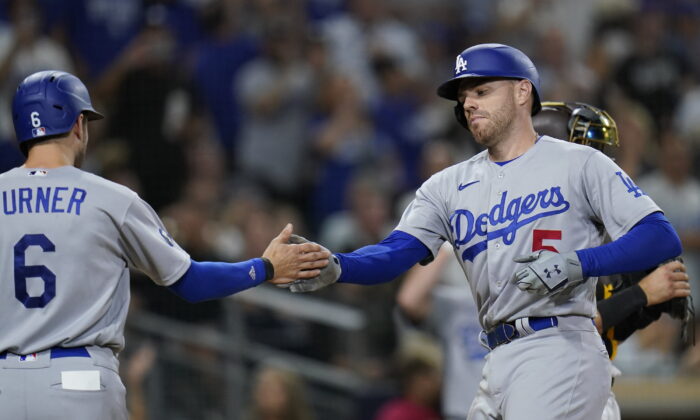 Los Angeles Dodgers' Freddie Freeman, right, is greeted by teammate Trea Turner after hitting a two-run home run during the seventh inning of a baseball game against the San Diego Padres, in San Diego, Sept. 10, 2022. (Gregory Bull/AP Photo)