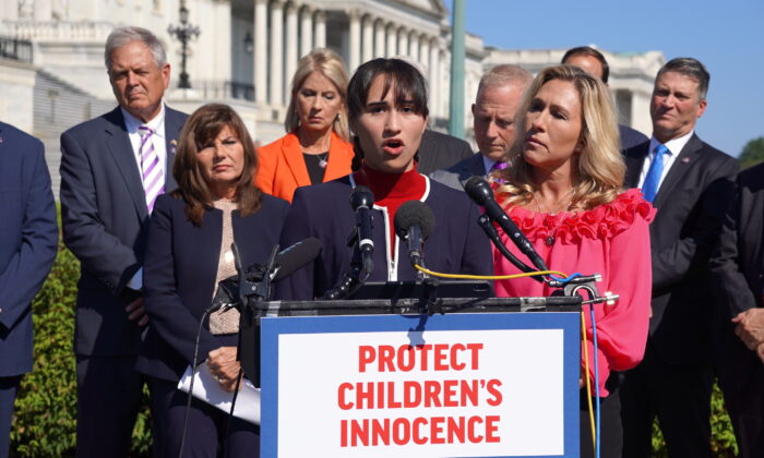 Chloe Cole, an ex-transgender teen, speaks in support of the Protect Children's Innocence as Rep. Marjorie Taylor Greene (R-Ga.) looks on outside the U.S. Capitol in Washington on Sept. 20, 2022. (Terri Wu/The Epoch Times)