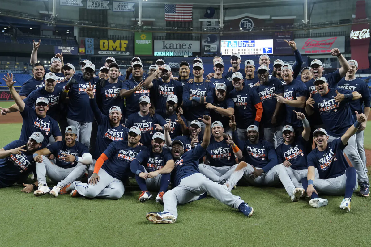 The Houston Astros pose for a photo after clinching the American League West title with a win over the Tampa Bay Rays during a baseball game in St. Petersburg, Fla., Sept. 19, 2022. (Chris O'Meara/AP Photo)