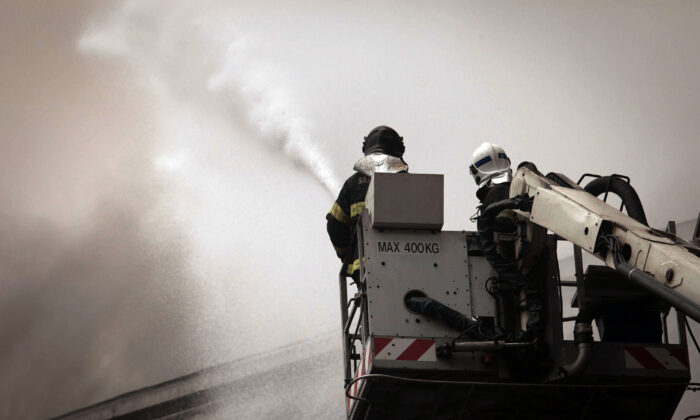 Firefighters attempt to extinguish a fire in a warehouse with sugar at the port of Santos, the biggest of Latin America, some 60 km of Sao Paulo, on Oct. 18, 2013. (Ricardo Nogueira/AFP via Getty Images)