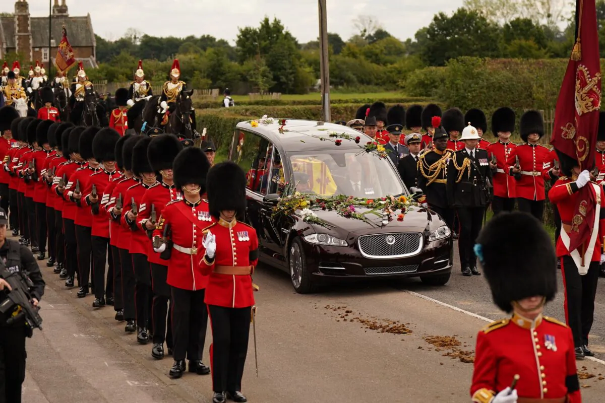 The hearse carrying the coffin of Queen Elizabeth II makes its journey from Westminster Abbey in London to St George's Chapel at Windsor Castle in Berkshire, England, on Sept. 19, 2022. (Niall Carson/Pool Photo via AP)