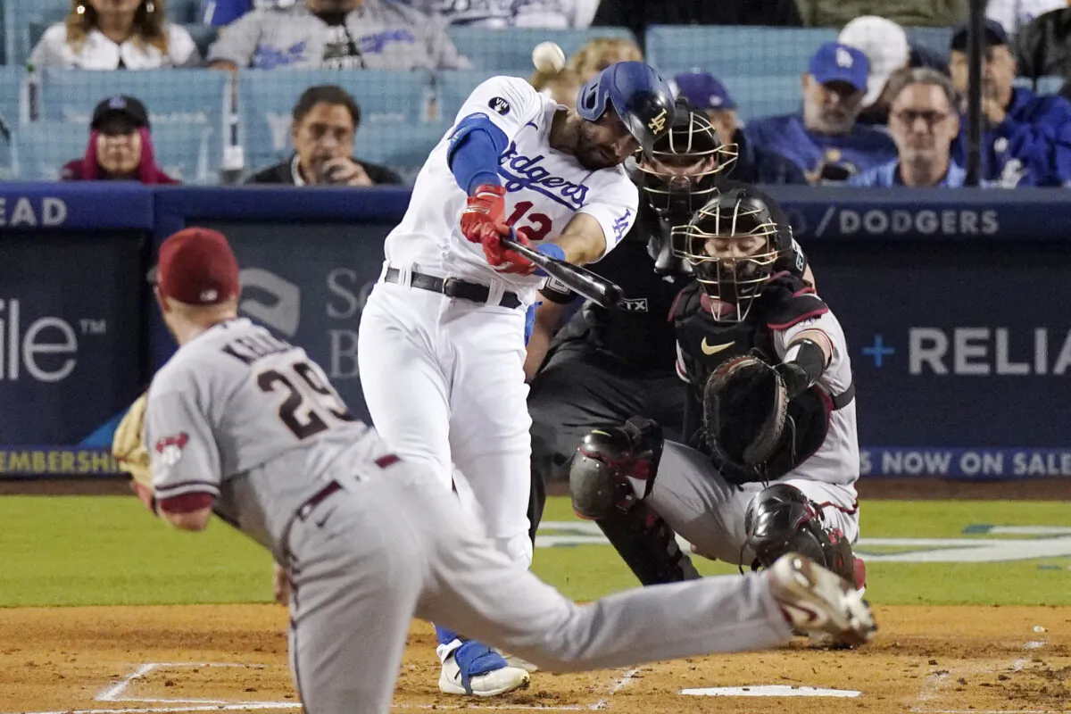 Los Angeles Dodgers' Joey Gallo, second from left, hits a solo home run as Arizona Diamondbacks starting pitcher Merrill Kelly, left, watches along with catcher Carson Kelly, right, and home plate umpire Adam Beck during the second inning of a baseball game in Los Angeles, on Sept. 19, 2022. (Mark J. Terrill/AP Photo)