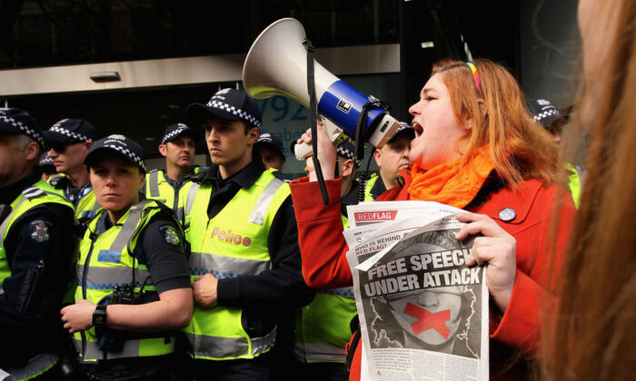Protesters gather outside as Prime Minister Tony Abbott opens the Peter Doherty Institute for Infection and Immuminty facility in Melbourne, Australia, on Sept. 12, 2014. (Robert Prezioso/Getty Images)