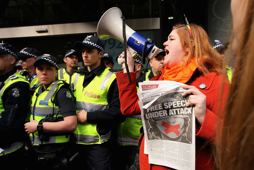 Protesters gather outside as Prime Minister Tony Abbott opens the Peter Doherty Institute for Infection and Immuminty facility in Melbourne, Australia, on Sept. 12, 2014. (Robert Prezioso/Getty Images)