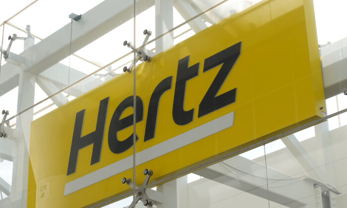 Signage at Hertz rental car at John F. Kennedy International Airport in Queens, New York, on March 30, 2022. (Andrew Kelly/Reuters)