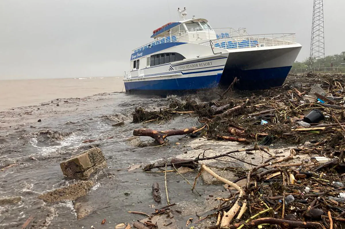 A boat lies washed up on shore after the passing of Hurricane Fiona in Ponce, Puerto Rico, on Sept. 19, 2022. (Ricardo Ortiz/Reuters)